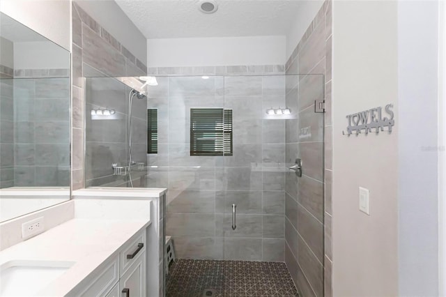 full bathroom with a stall shower and vanity