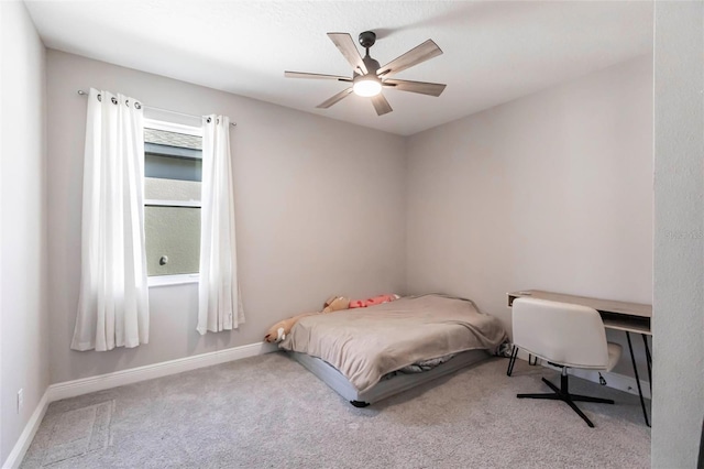 bedroom with a ceiling fan, baseboards, and carpet flooring