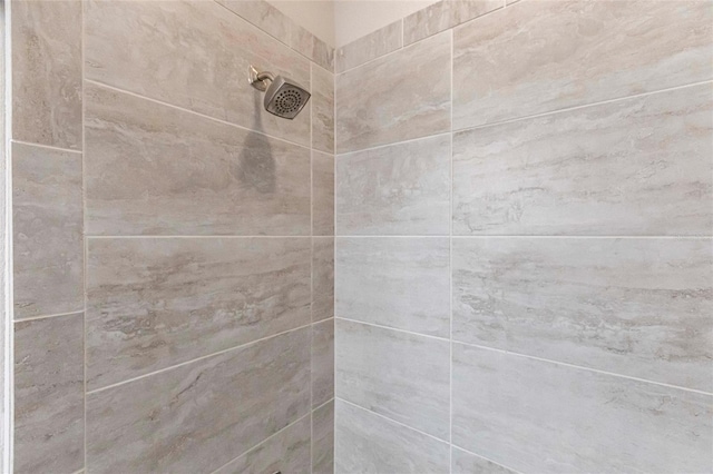 interior details with a tile shower