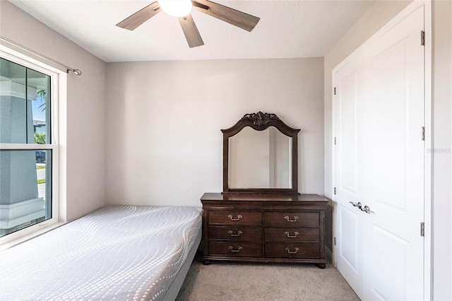 bedroom featuring light colored carpet and ceiling fan