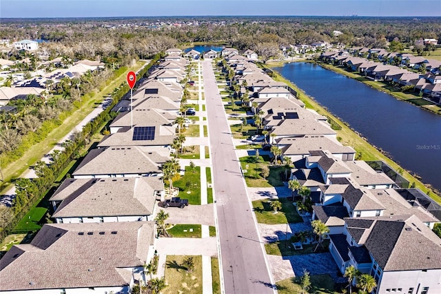 drone / aerial view featuring a water view and a residential view