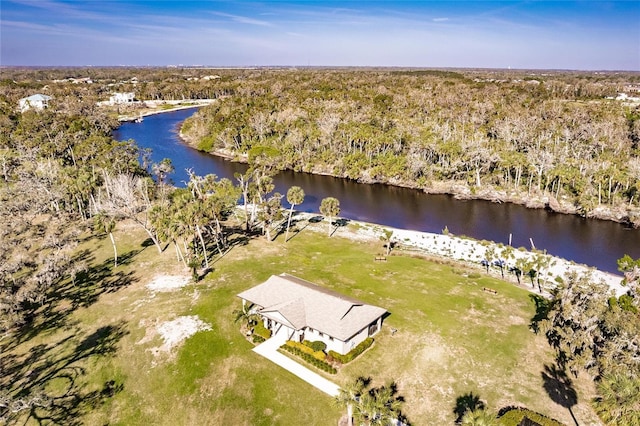 drone / aerial view featuring a water view and a wooded view