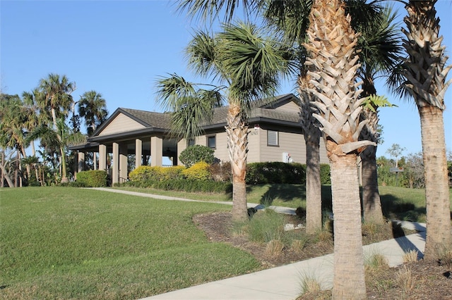 view of front of property with roof with shingles and a front lawn