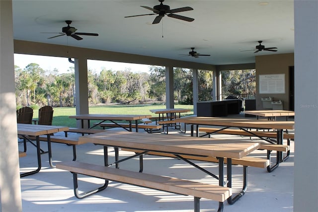 view of home's community with a yard, outdoor dining space, and a patio area