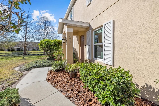 view of side of property with stucco siding