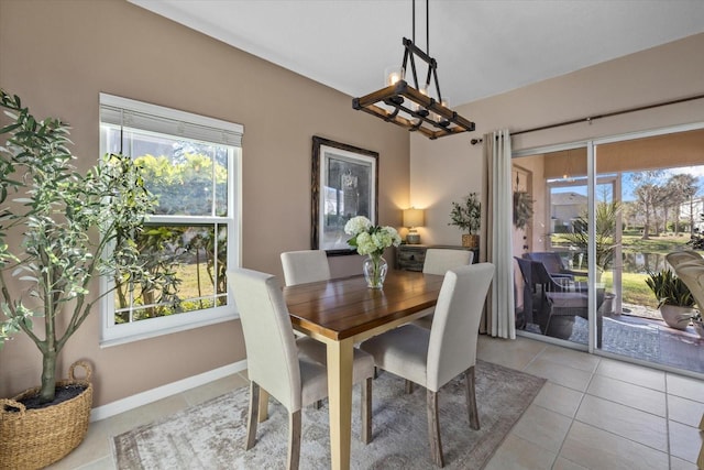 dining room with light tile patterned floors, a wealth of natural light, and baseboards