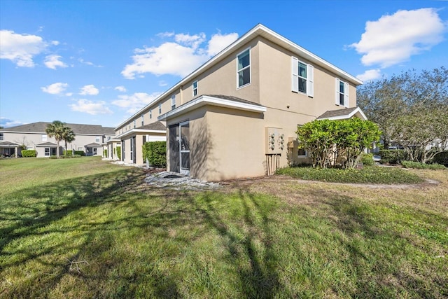 view of property exterior featuring a lawn and stucco siding