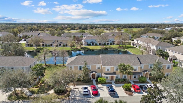 drone / aerial view with a water view and a residential view