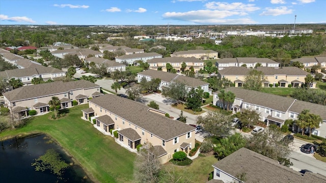 drone / aerial view featuring a water view and a residential view