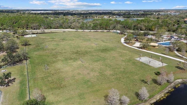 birds eye view of property with a water view and a view of trees