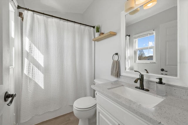 full bath with toilet, a shower with curtain, wood finished floors, and vanity