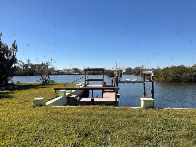 dock area featuring a lawn, a water view, and boat lift