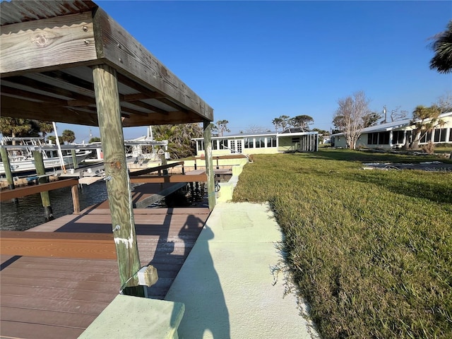 dock area featuring a yard and boat lift