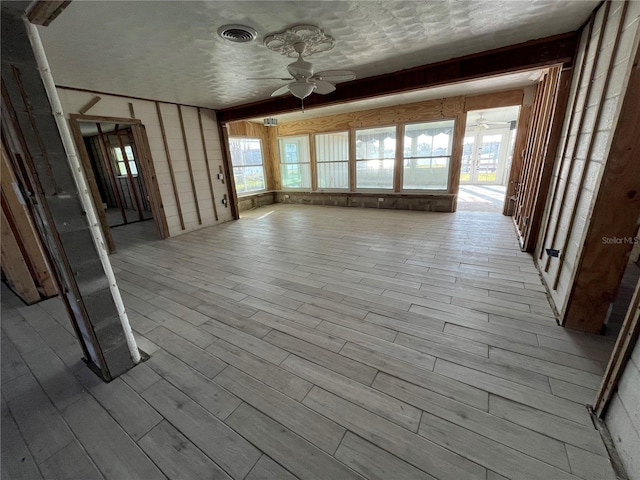 interior space with visible vents, plenty of natural light, and a ceiling fan