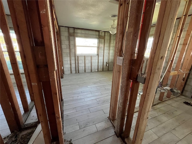 miscellaneous room featuring ceiling fan, a textured ceiling, and visible vents