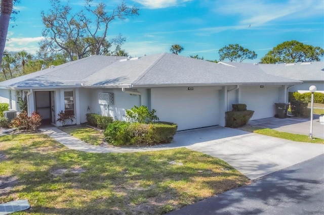 single story home featuring concrete driveway, a front lawn, stucco siding, and central air condition unit