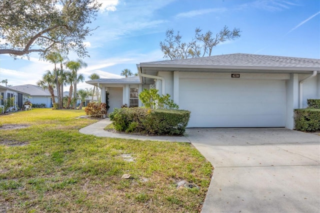 ranch-style home with an attached garage, concrete driveway, a front yard, and stucco siding