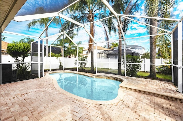 view of pool featuring a patio area, a fenced backyard, a fenced in pool, and a lanai