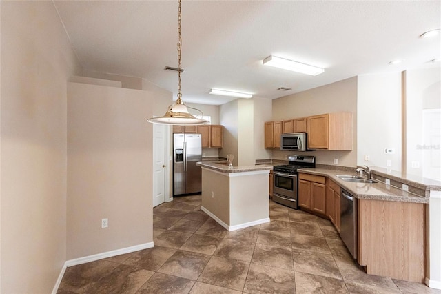 kitchen featuring stainless steel appliances, light countertops, a sink, a kitchen island, and a peninsula