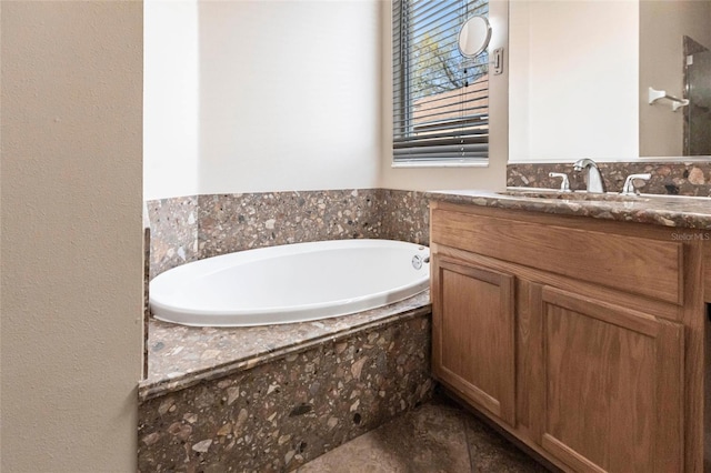 bathroom featuring a garden tub and vanity