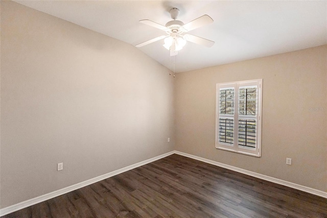 empty room with dark wood-style floors, ceiling fan, lofted ceiling, and baseboards