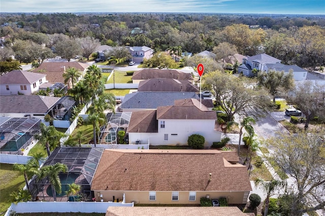 birds eye view of property with a residential view and a view of trees