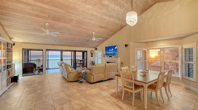 dining area with light tile patterned flooring, ceiling fan with notable chandelier, a fireplace, and wooden ceiling