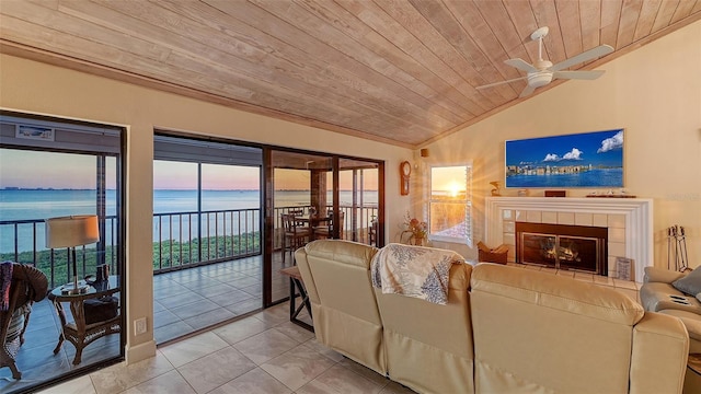 living room with light tile patterned floors, a tile fireplace, wood ceiling, ceiling fan, and vaulted ceiling