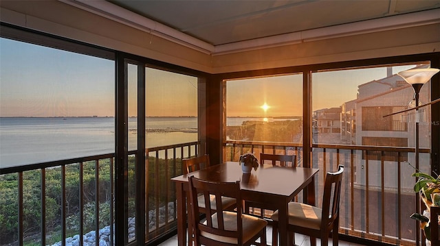 sunroom / solarium with a water view