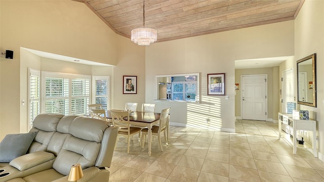 dining space featuring an inviting chandelier, wood ceiling, a high ceiling, and light tile patterned floors