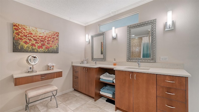 full bath with double vanity, crown molding, a textured ceiling, and a sink