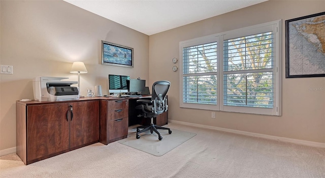 home office featuring light carpet and baseboards