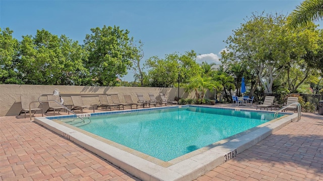 pool featuring a patio and fence