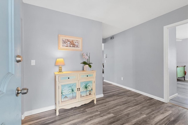 interior space featuring wood finished floors, visible vents, and baseboards