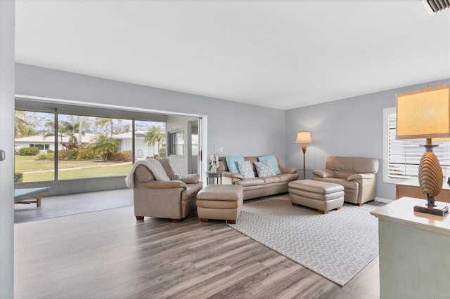 living room featuring visible vents and wood finished floors