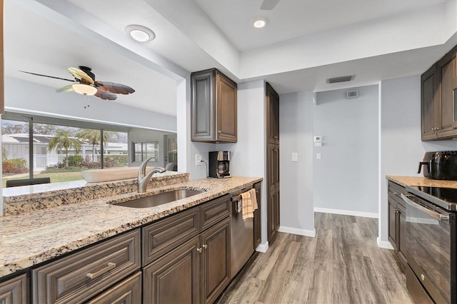 kitchen with a ceiling fan, light stone counters, black range with electric stovetop, a sink, and stainless steel dishwasher