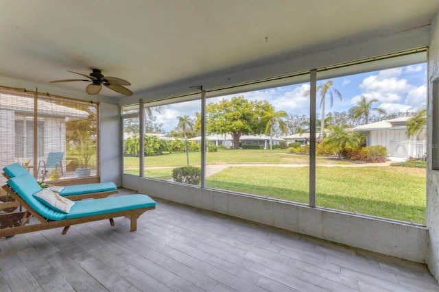 unfurnished sunroom featuring ceiling fan