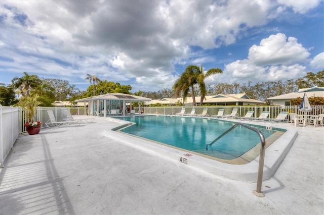 community pool featuring a patio area and fence