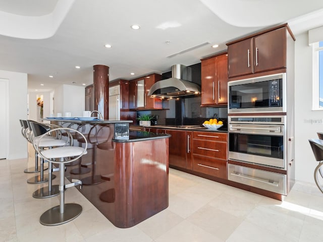 534 Beach Rd, Sarasota, FL 34242 - kitchen with dark countertops, oven, built in microwave, wall chimney exhaust hood, and a warming drawer