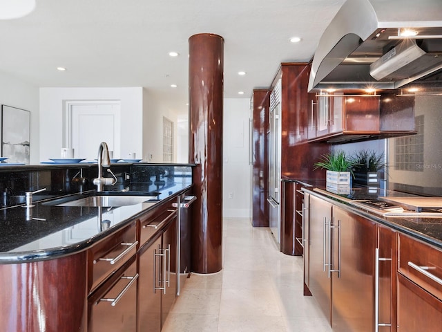 534 Beach Rd, Sarasota, FL 34242 - kitchen with dark stone countertops, wall chimney exhaust hood, recessed lighting, and a sink