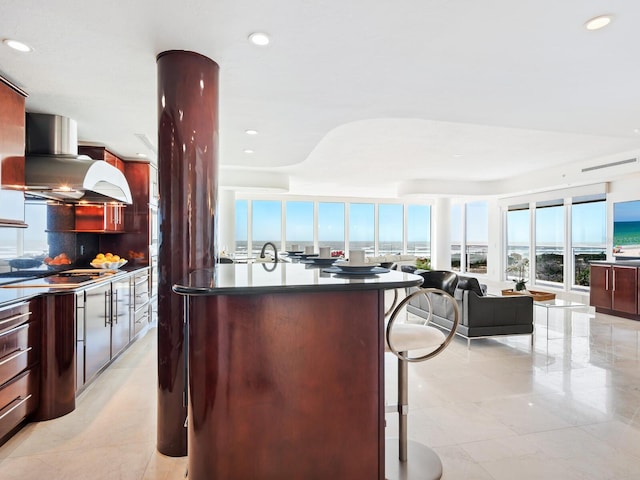 534 Beach Rd, Sarasota, FL 34242 - kitchen with a kitchen island, dark countertops, open floor plan, a breakfast bar area, and island range hood