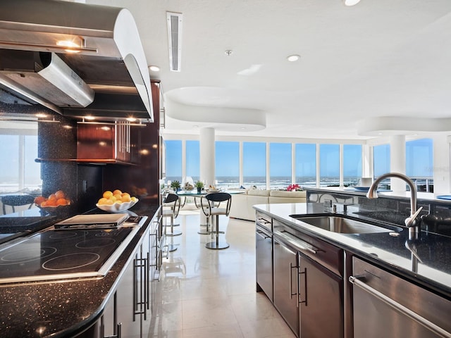 534 Beach Rd, Sarasota, FL 34242 - kitchen featuring plenty of natural light, ventilation hood, black electric cooktop, and a sink