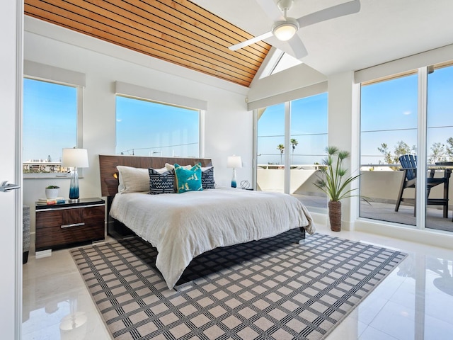 534 Beach Rd, Sarasota, FL 34242 - bedroom with multiple windows, lofted ceiling, light tile patterned flooring, and access to outside