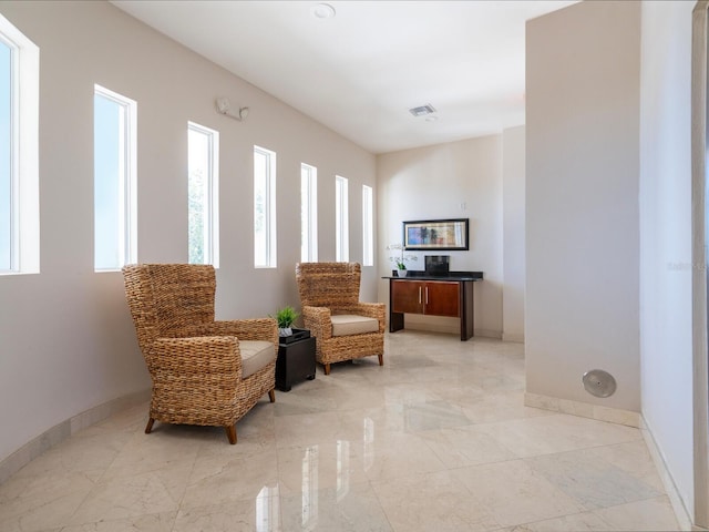 534 Beach Rd, Sarasota, FL 34242 - living area with visible vents, baseboards, and marble finish floor