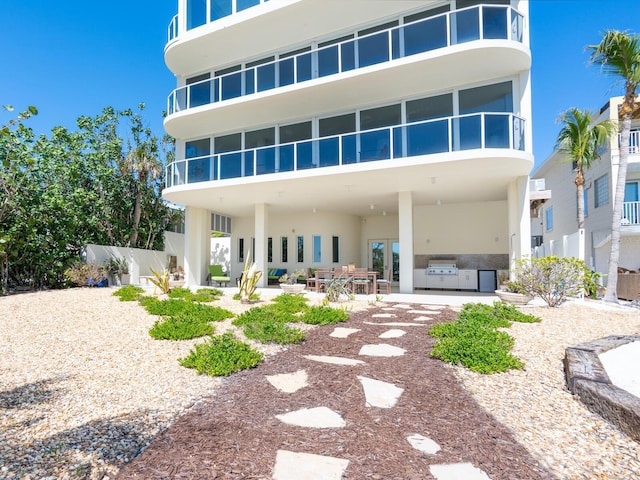 534 Beach Rd, Sarasota, FL 34242 - back of house with stucco siding, a patio, and a sunroom