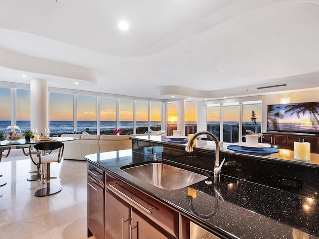534 Beach Rd, Sarasota, FL 34242 - kitchen with recessed lighting, open floor plan, dark stone countertops, and a sink