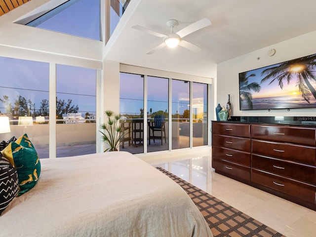534 Beach Rd, Sarasota, FL 34242 - bedroom with light tile patterned floors, a ceiling fan, and access to outside
