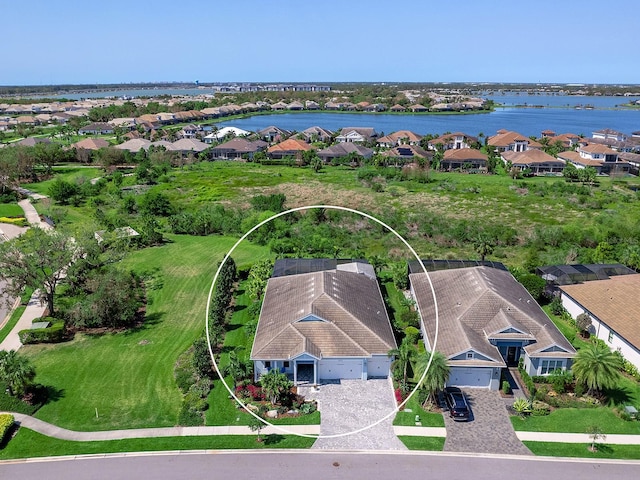 birds eye view of property with a residential view and a water view