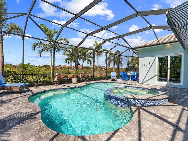 view of swimming pool featuring a lanai, a patio area, and a pool with connected hot tub