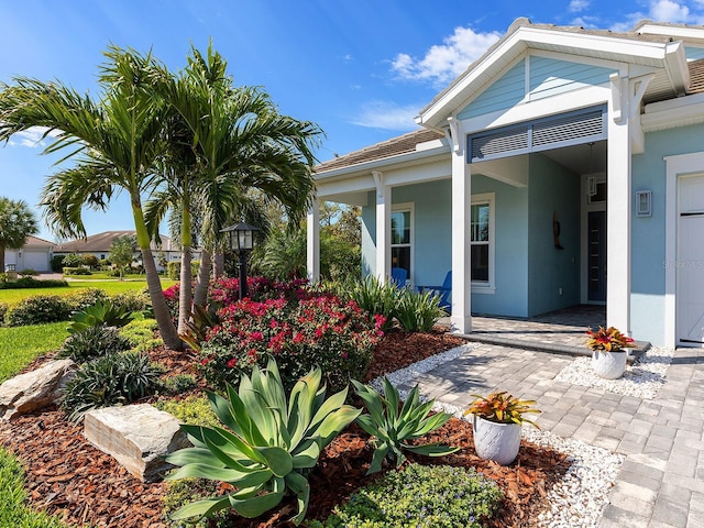 exterior space featuring stucco siding and a porch